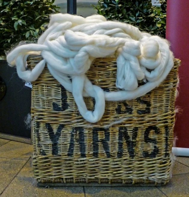 the handles of the basket are covered with a thick white cotton