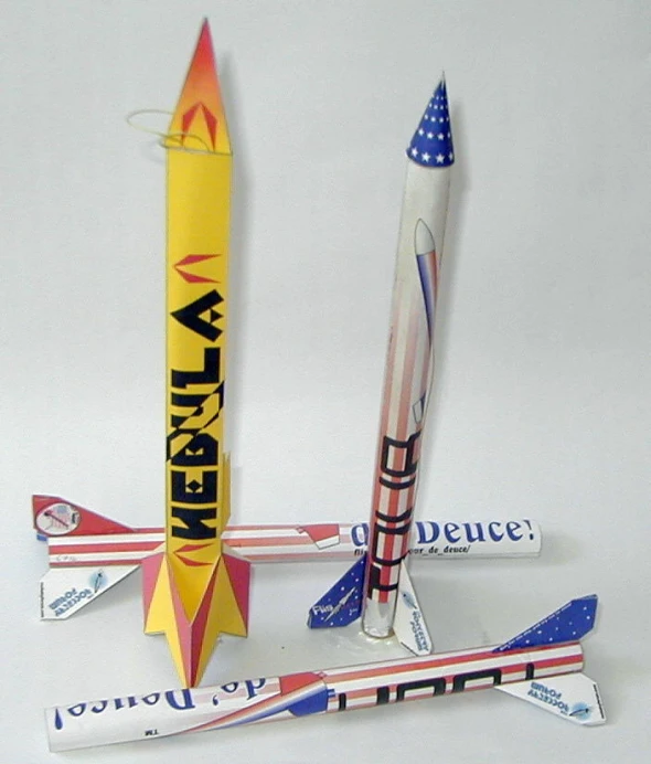 these are several models of a rocket and another one that is on the same piece