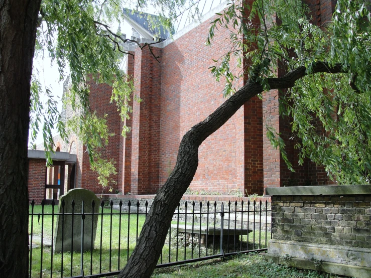 an abandoned church is behind a fence