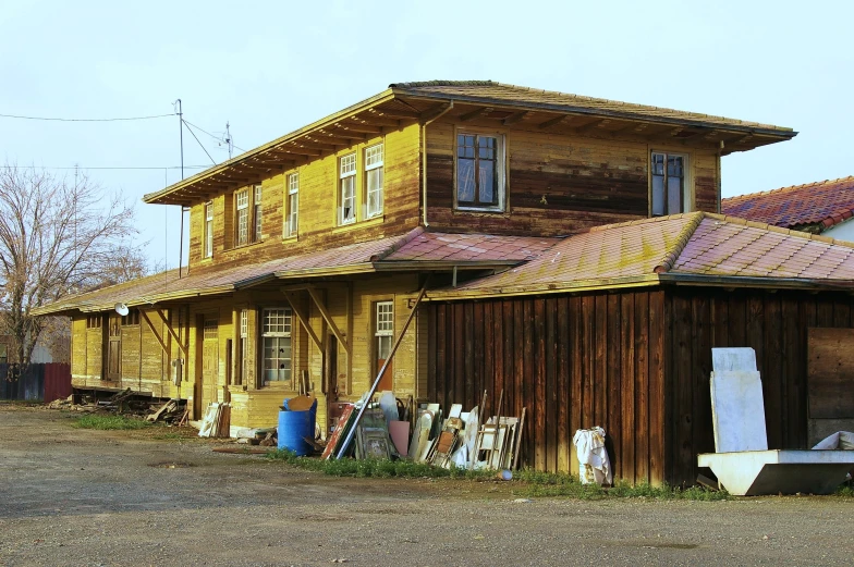 a big old yellow building sitting next to a small white van