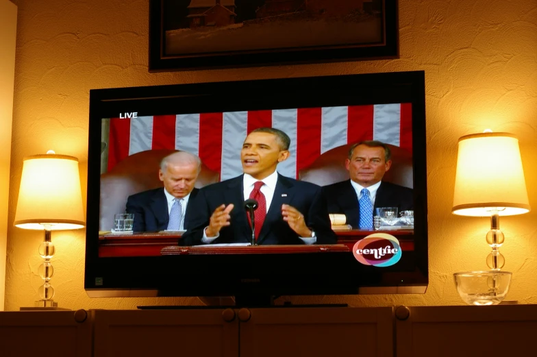 a television screen with two men on it in the middle of a room