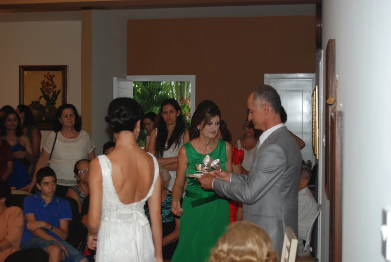 a man giving a bride a wedding ring