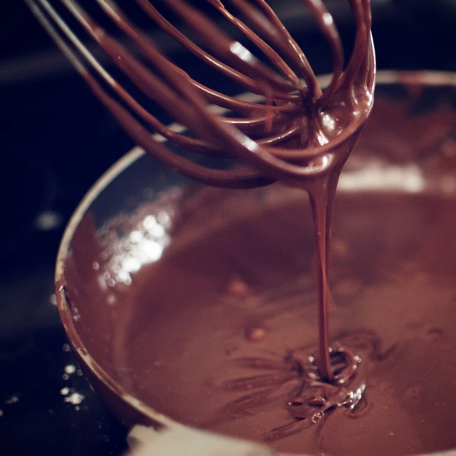 the chocolate is melting in a small pot