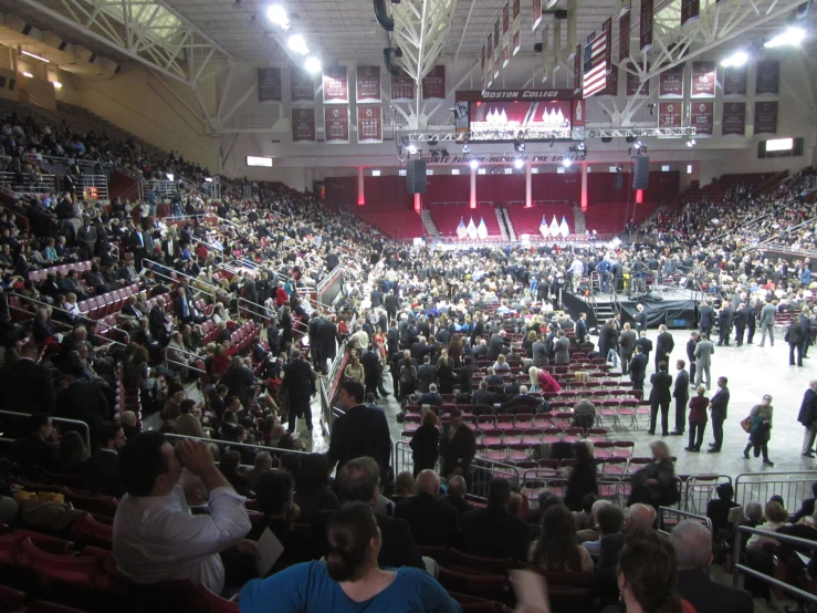 a bunch of people in a large auditorium watching soing