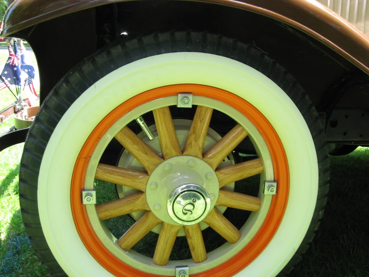 an orange and white wheel on a vintage car