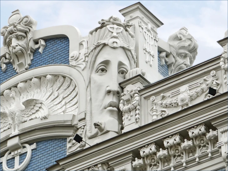 the top portion of a building with an elaborate face on it