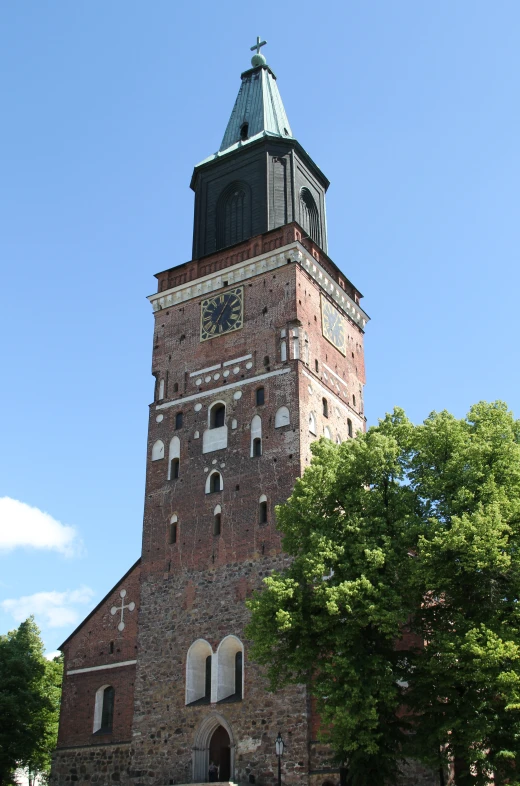 a tall brick tower with a clock at the top