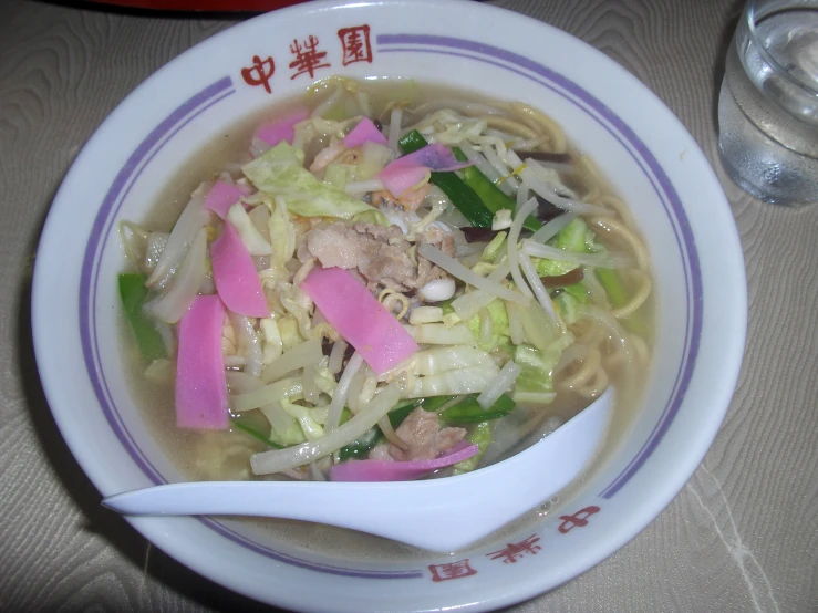 a bowl filled with meat, cabbage, and broccoli