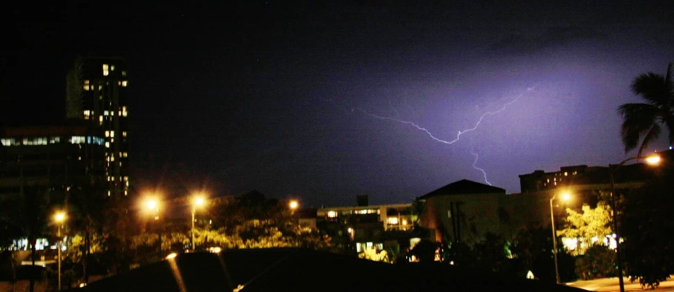 a lightning is shining over the city at night