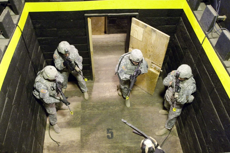 military personnel walking down a hallway with tools