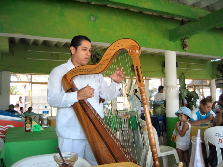 a man playing the harp in a restaurant