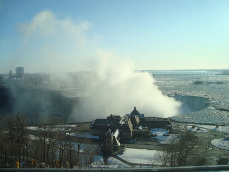 steam rises off a building in a river area