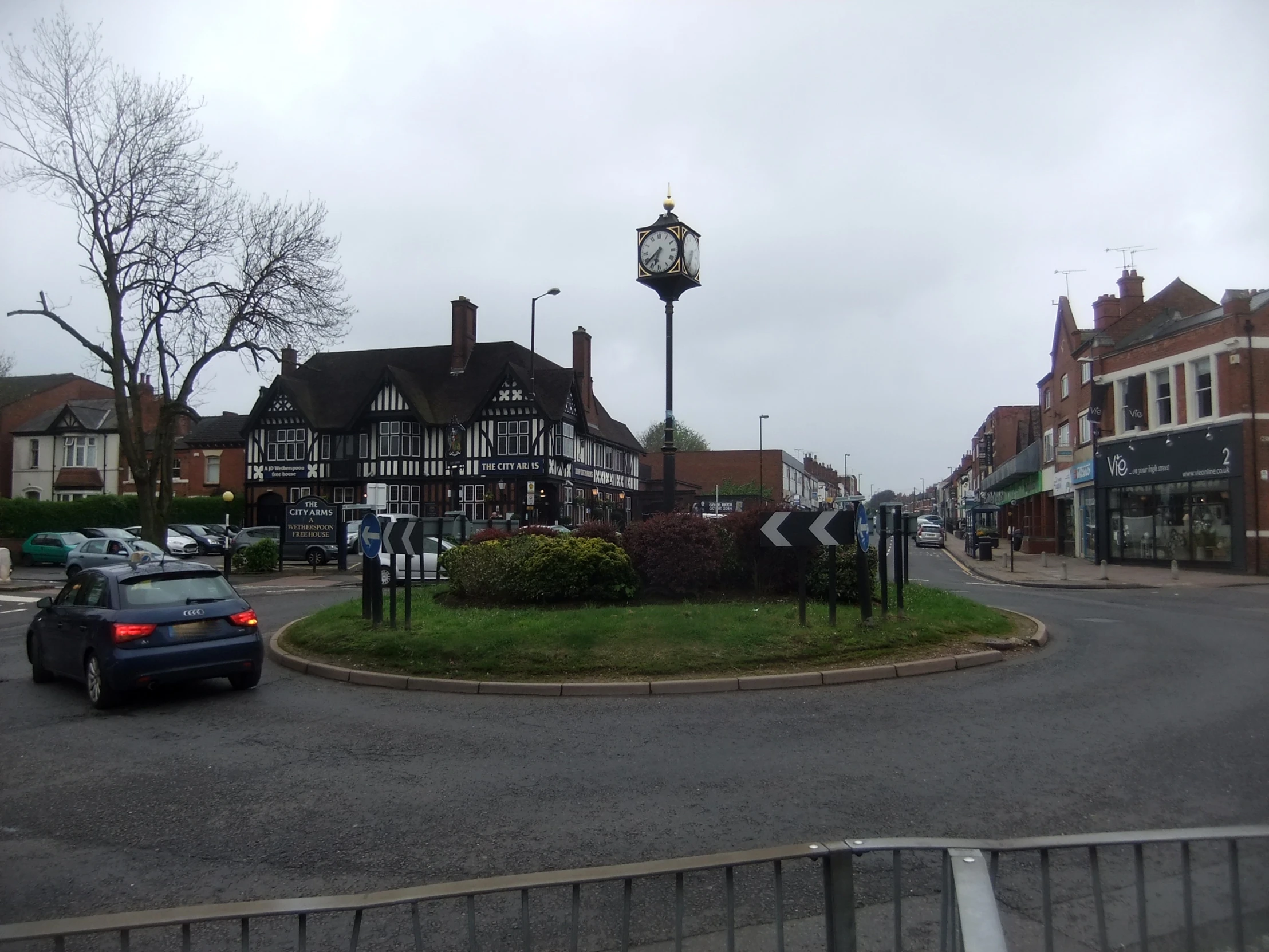 an intersection with a clock in the middle