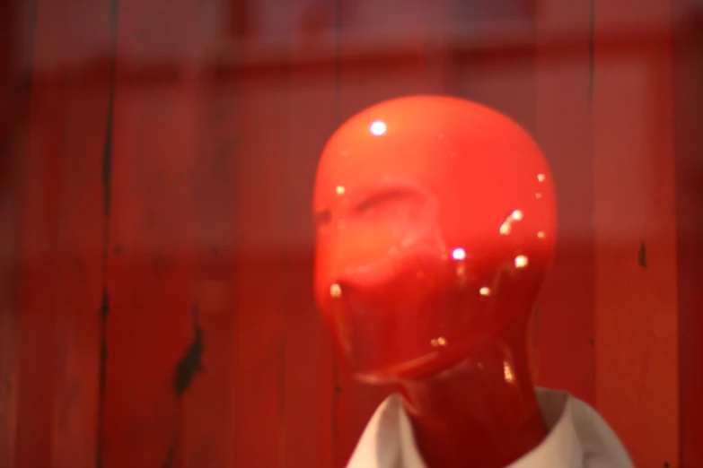 a person wearing a white shirt and a red mannequin