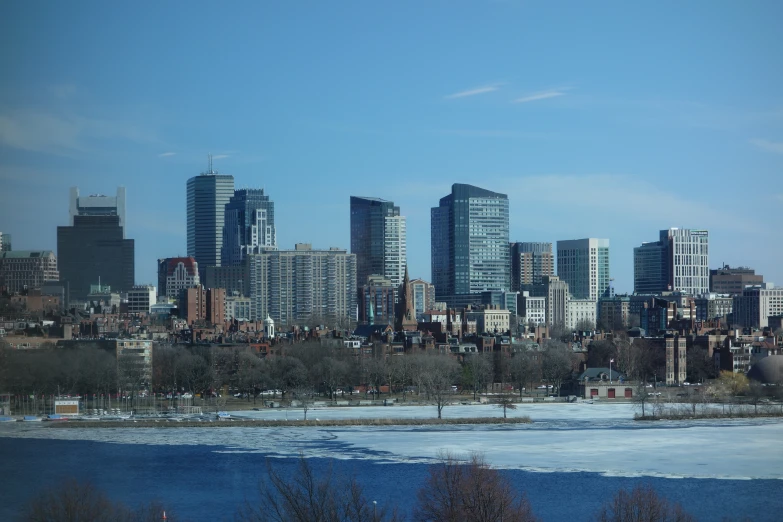 some buildings near the water in front of blue sky