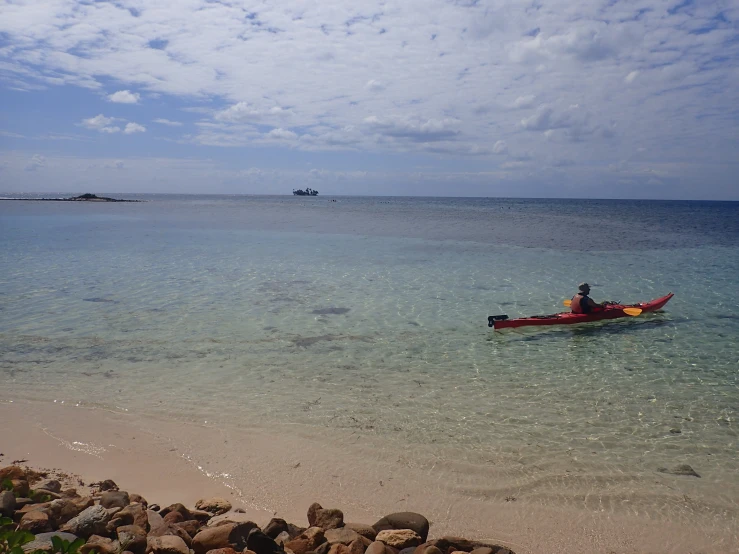 there is a man sitting in a boat out on the water