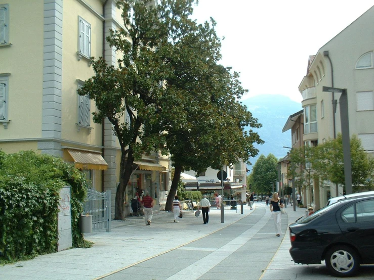 two cars are driving on the narrow street