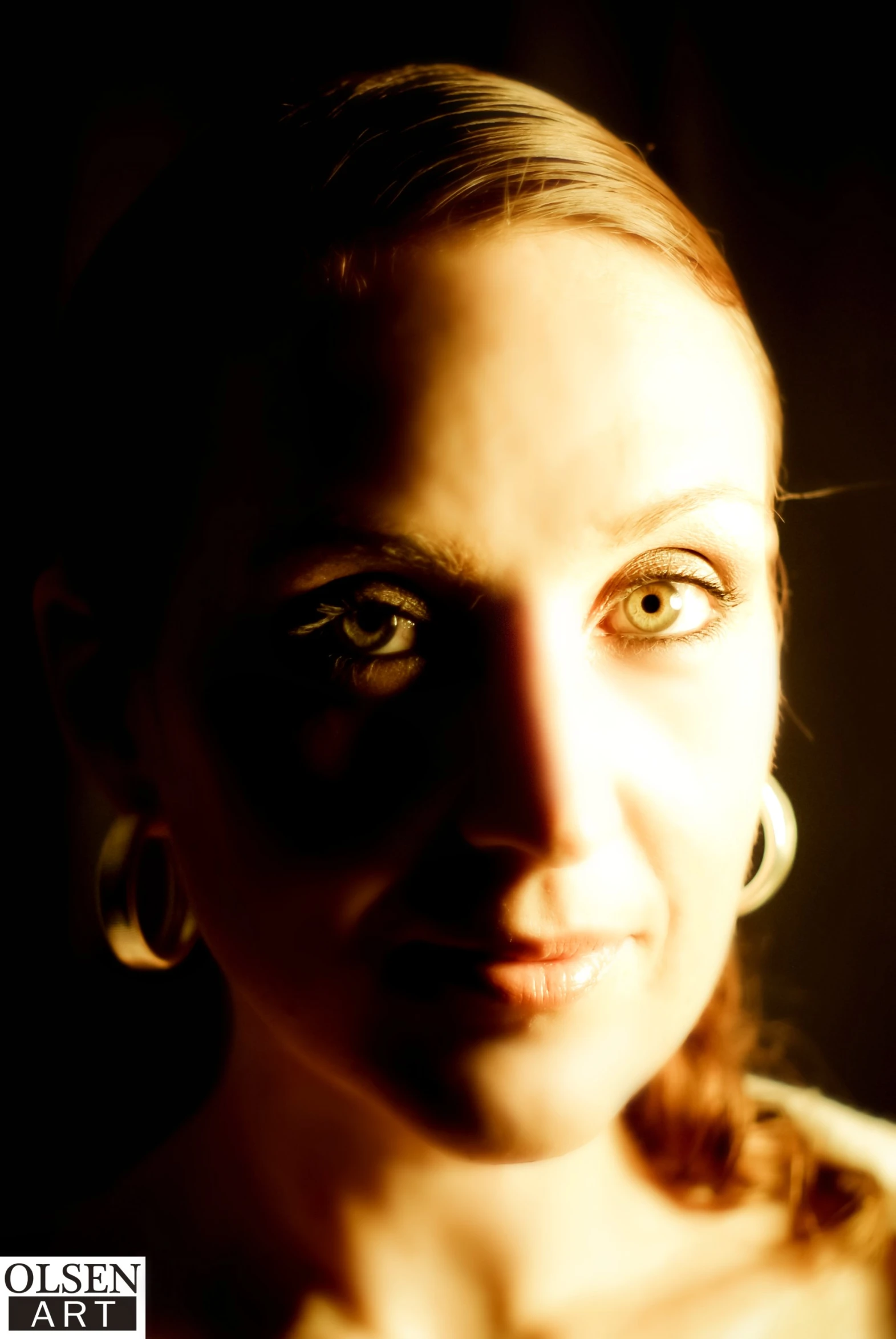 a woman in the dark with makeup on her face and blue eyes