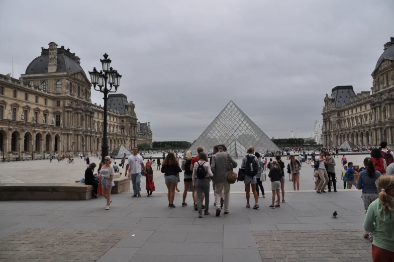 people standing around in front of the pyramid