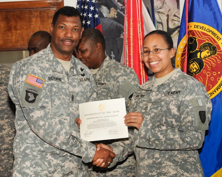 two people in military uniform holding a document