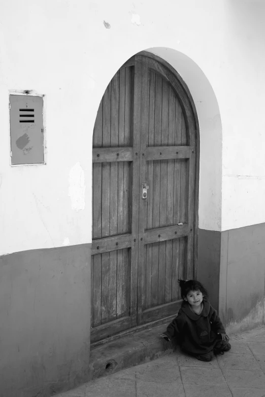 a woman laying on the ground by a door