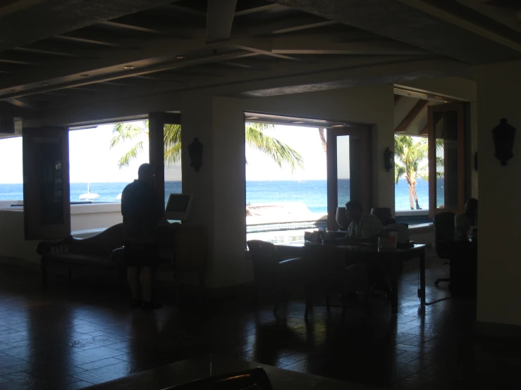 a couple of people sitting at tables in a large room