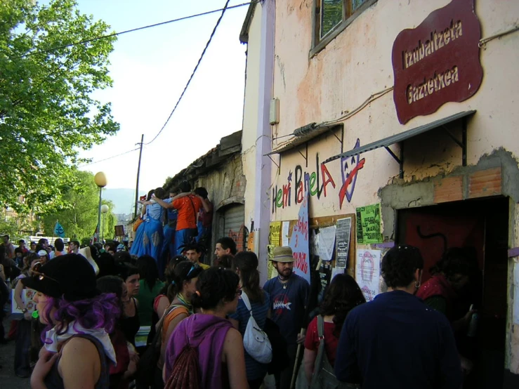 many people are outside with a large sign