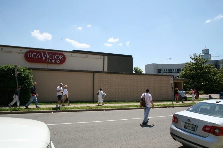 a few people are walking near the building