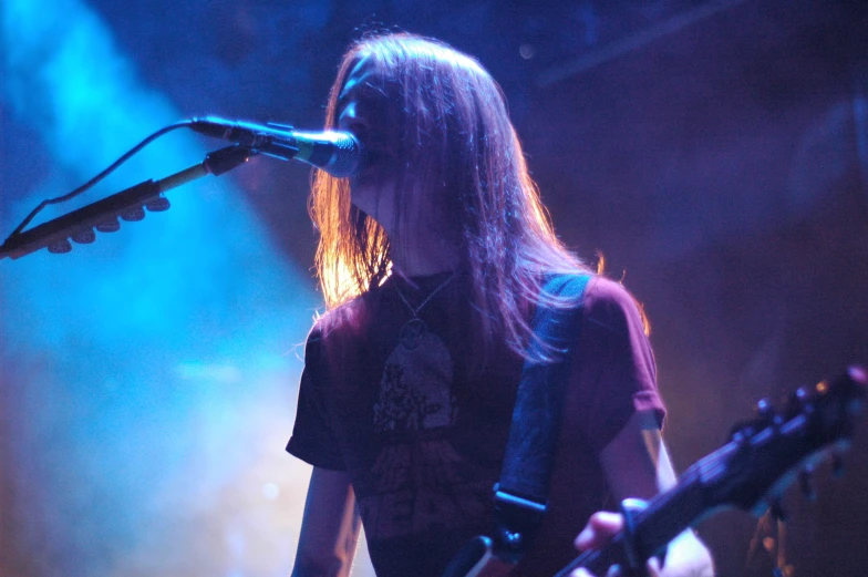 a man standing next to a microphone on stage