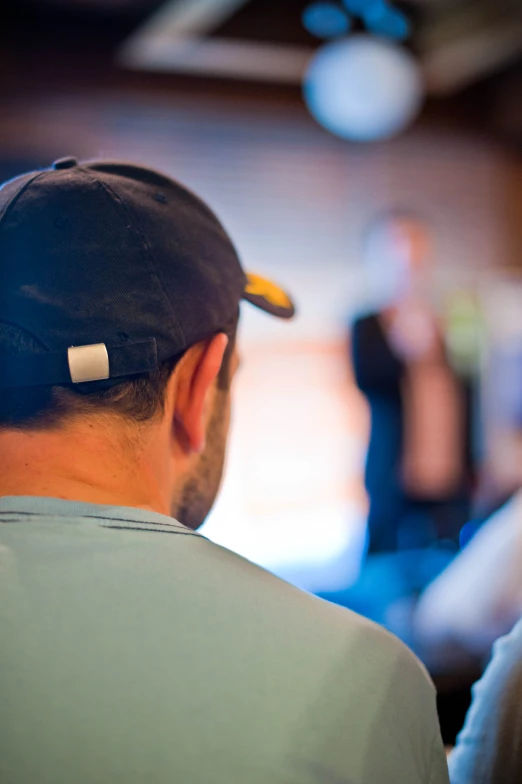 a man in headphones looks down at his cellphone