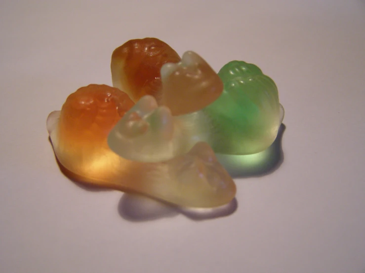 the gummy bears are colorful on a white surface
