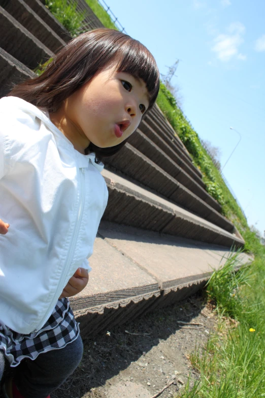 a  stands near the steps with her tongue sticking out