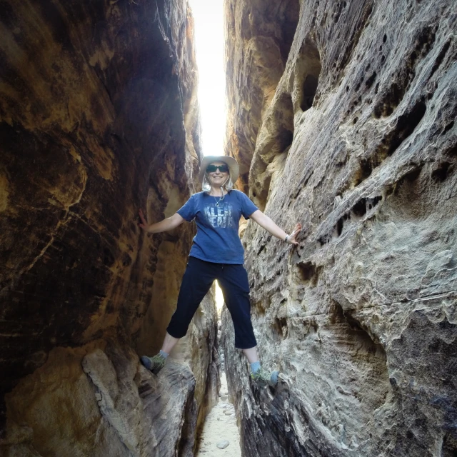 a person climbing up the side of a mountain