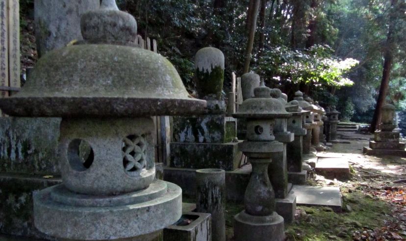 rows of concrete lanterns sitting on top of a cemetery