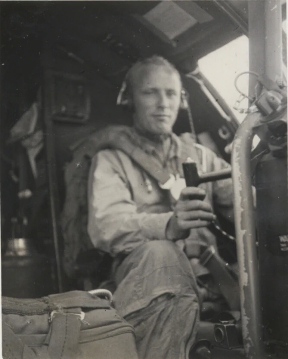 this is an old po of a man sitting in the cockpit of a plane