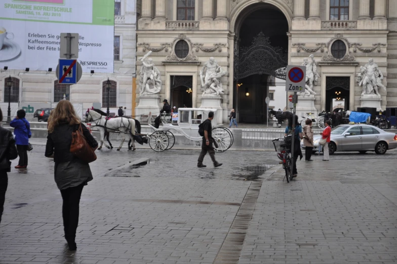 several people and horses in front of a building