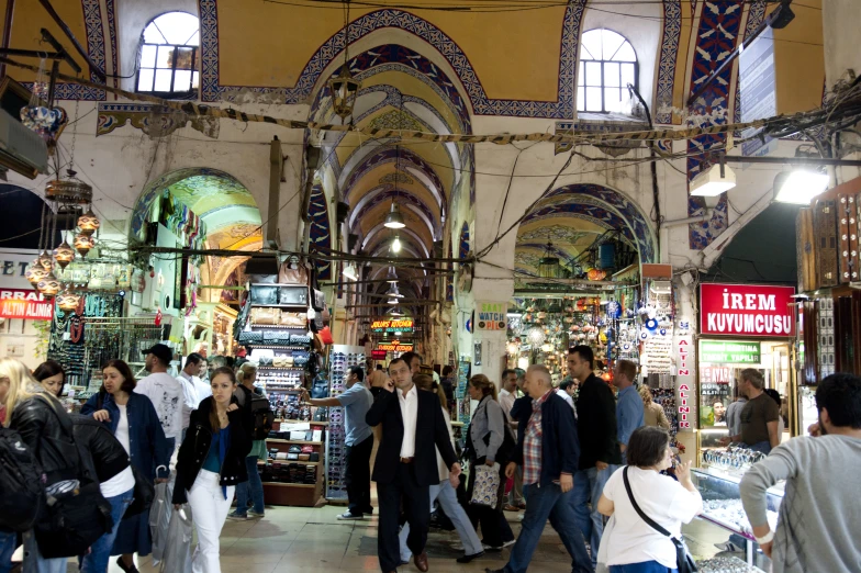 group of people walking around inside of a building