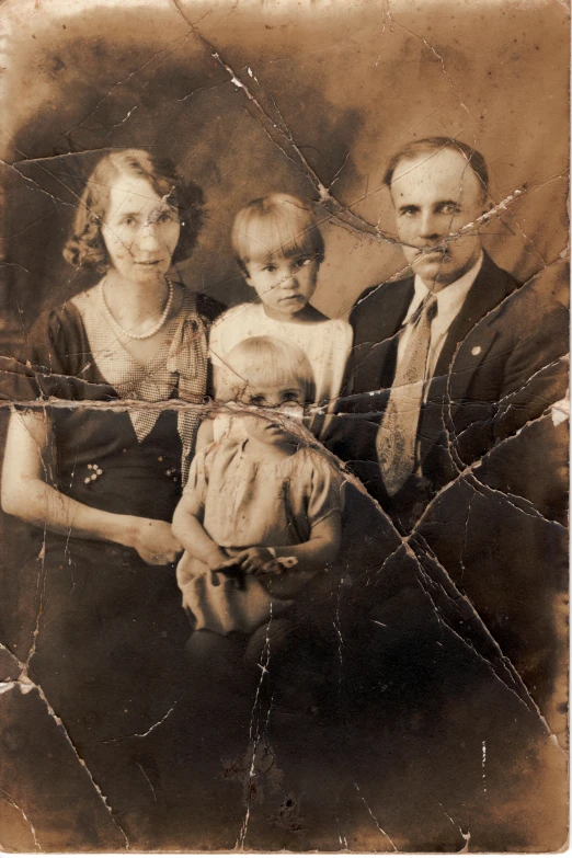 a family posing for a portrait with a dog