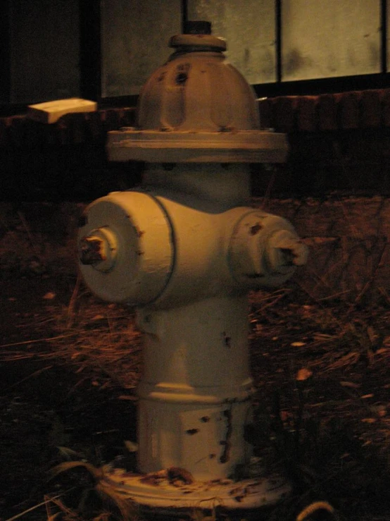 an old fire hydrant sits outside in the dirt