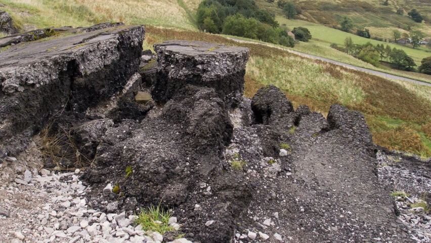 large rocks and gravel are embedded by large boulders