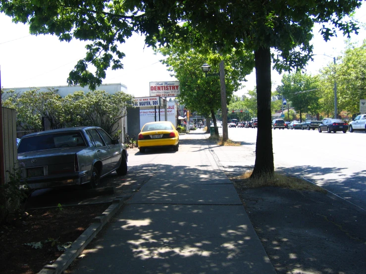 a view down a residential street with parked cars