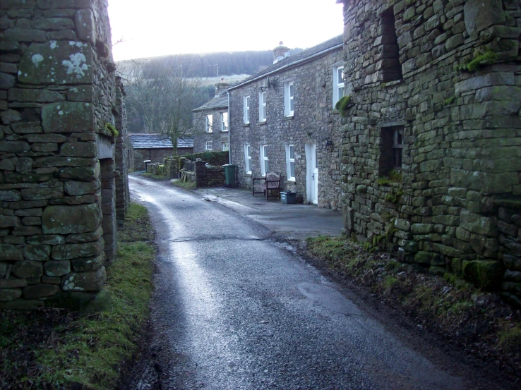 a empty road between brick buildings with windows