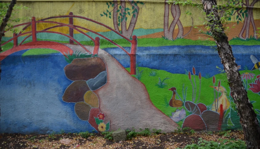 mural with bridge and trees on concrete block