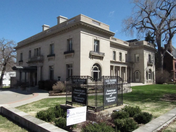 a large white house with a black iron fence