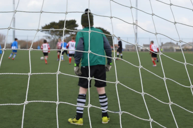 a man standing in the net while playing soccer