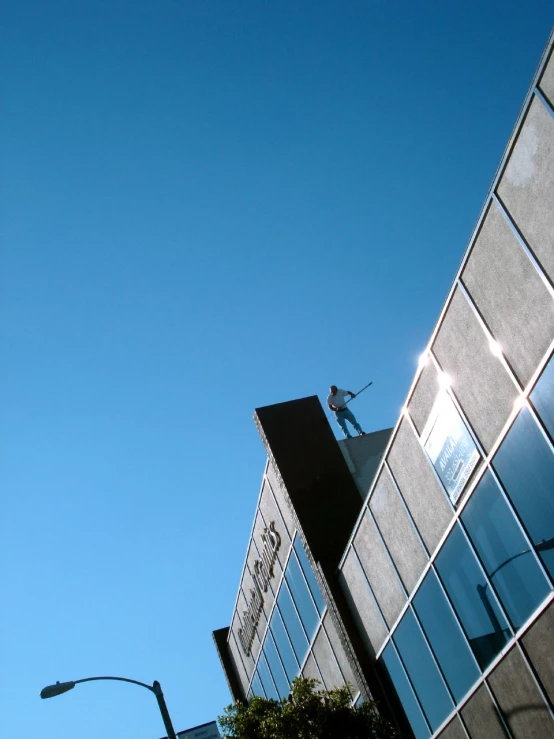 a person doing tricks on a skateboard near a building