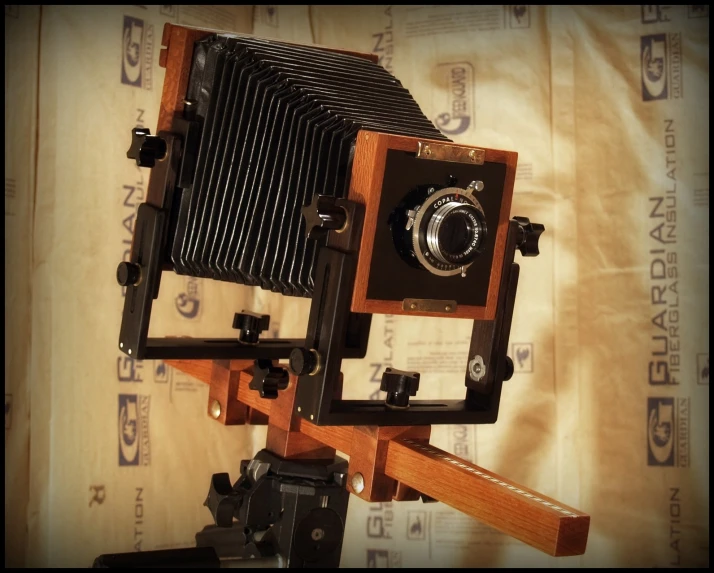 an old fashioned wooden camera sits on a tripod