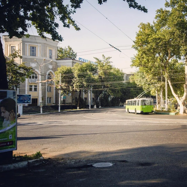 an old fashioned street car is on the streets in a city