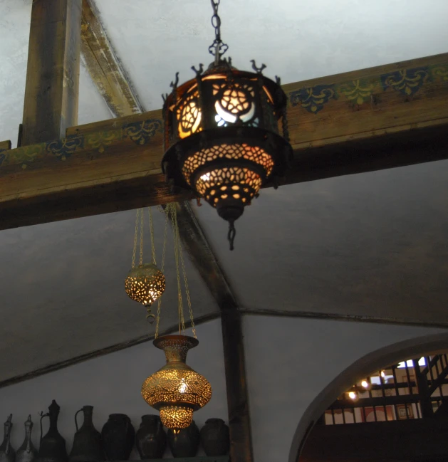 a group of chandeliers hanging from a wooden pole