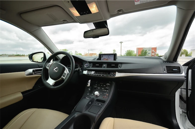 the inside view of a car with a dash light and steering wheel